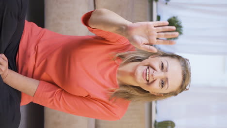Vertical-video-of-Happy-woman-waving-at-camera.